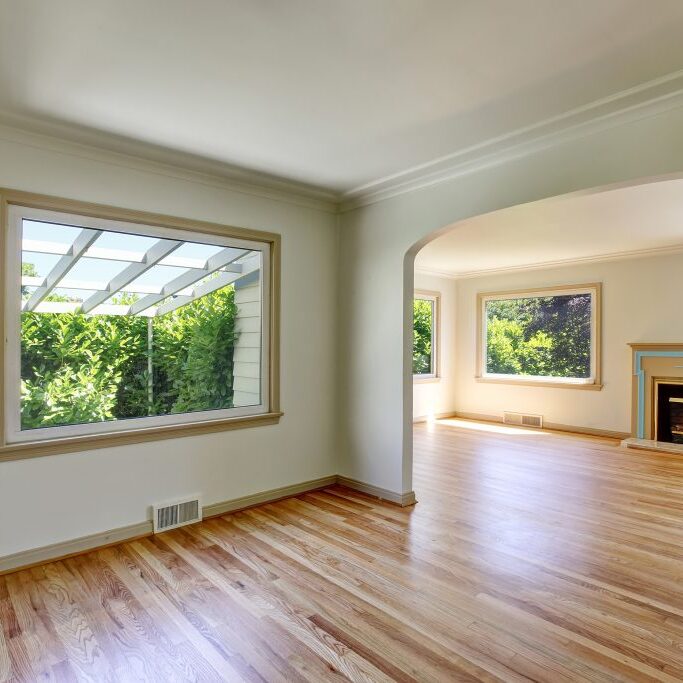 Open Floor Plan Empty Living Room With Polished Hardwood Floor. Open floor plan empty living room interior with polished hardwood floor and fireplace. Northwest USA